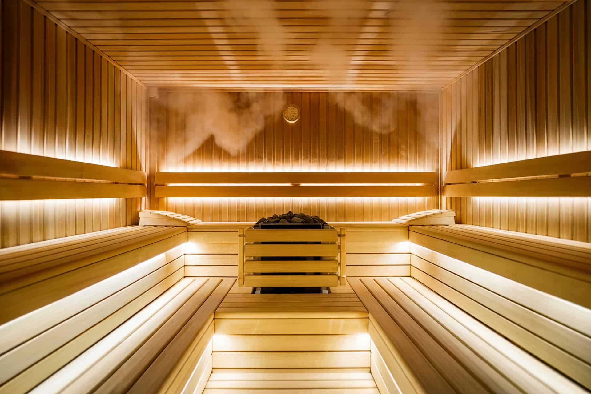 Cozy wooden sauna interior with gentle steam rising.